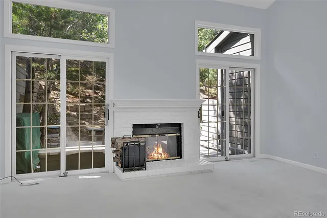 a living room with a fireplace and a window