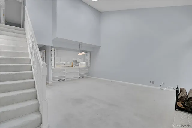 a view of an empty room with stairs