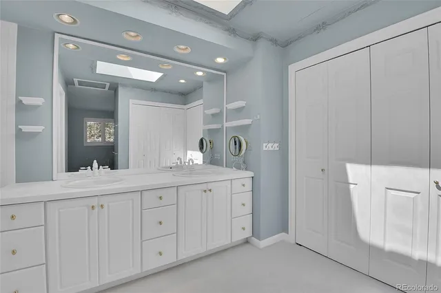 a bathroom with a double vanity sink and mirror