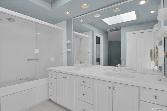 a bathroom with a granite countertop sink mirror and double
