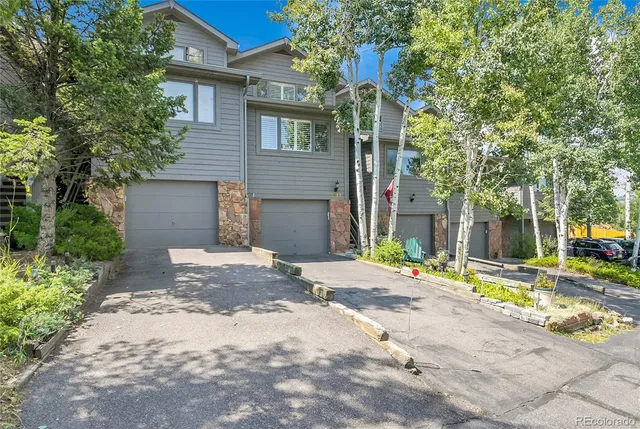 a view of a house with a yard and tree s