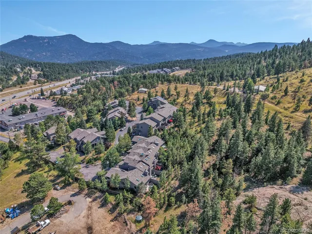 a view of a lush green hillside and houses