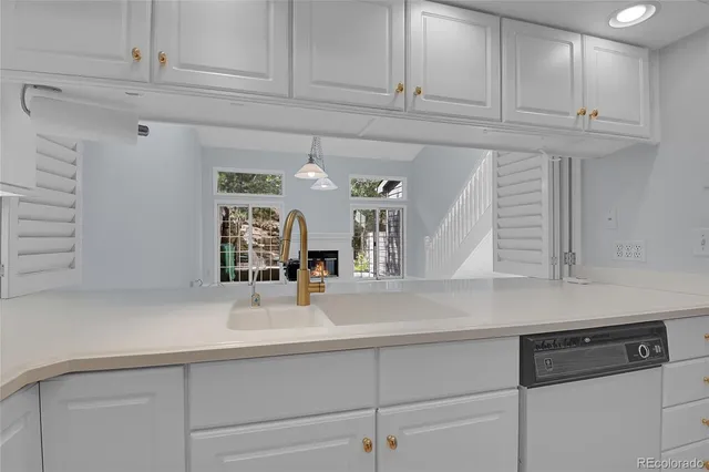 a kitchen with granite countertop a sink and cabinets