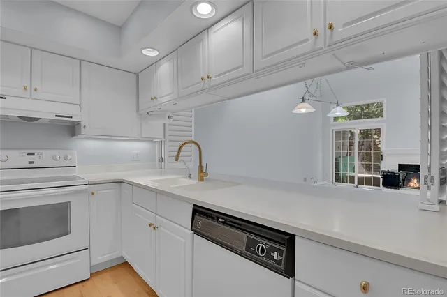a kitchen with a sink cabinets and appliances