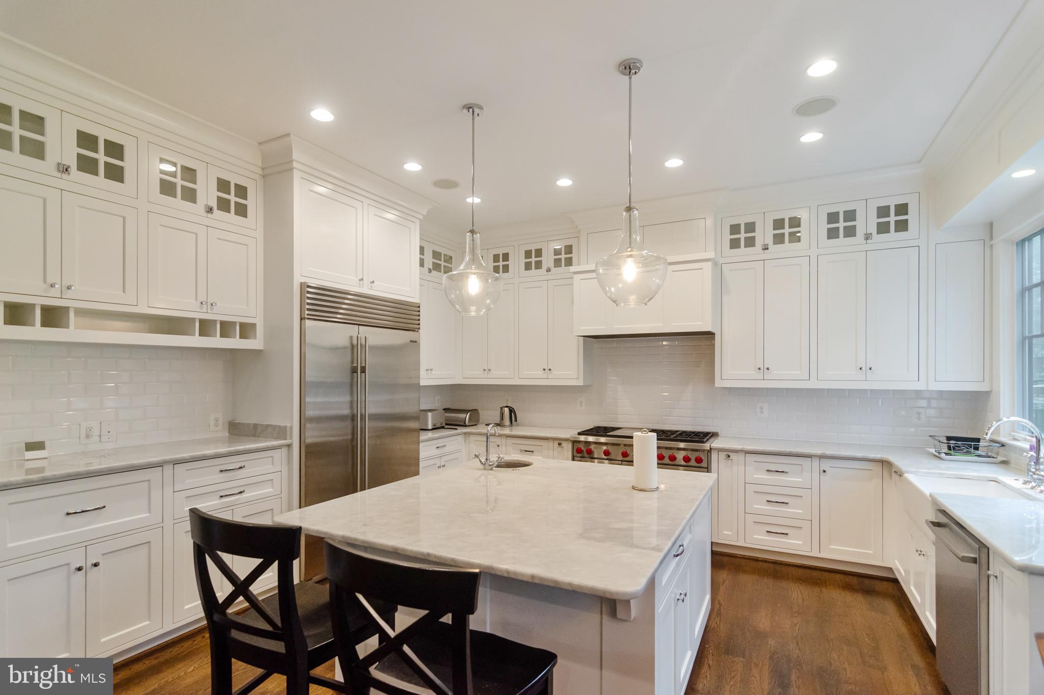 6801 Danforth Street McLean, VA 22101 - Photo 6 of 29 a kitchen that has a lot of cabinets and wooden floor