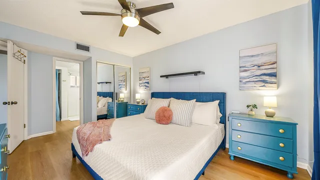 a bedroom with a bed and a chandelier