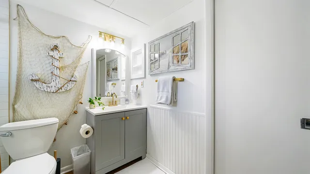a bathroom with a toilet sink and mirror