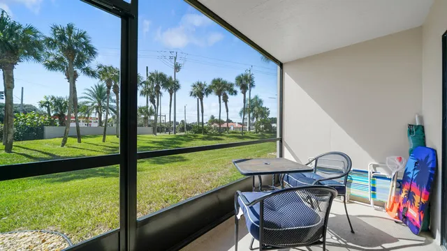 a view of a chairs and table in patio with a yard