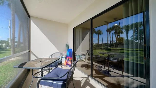 a view of a chairs and table in the balcony