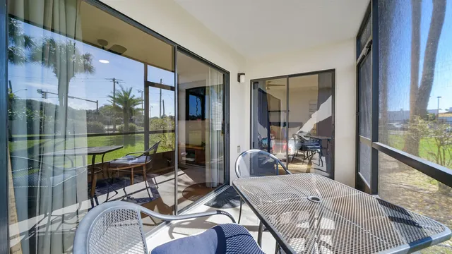 a bedroom with furniture and a floor to ceiling window