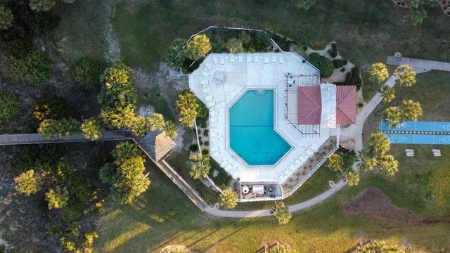 an aerial view of a house with a swimming pool