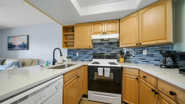 a kitchen with stainless steel appliances granite countertop a sink and cabinets