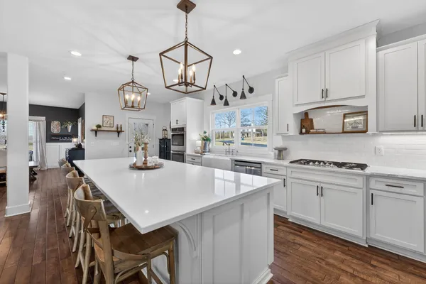 a kitchen with cabinets a center island and appliances