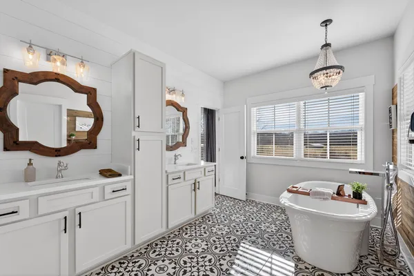 a bathroom with a sink toilet a mirror and bathtub