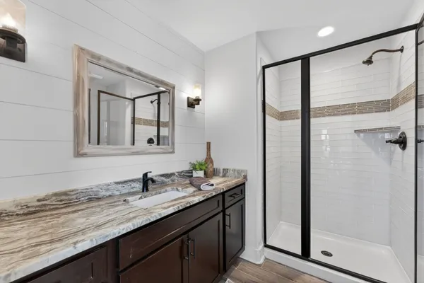 a bathroom with a granite countertop sink mirror and double