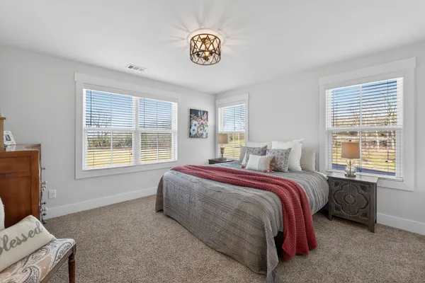 a spacious bedroom with a bed and a window