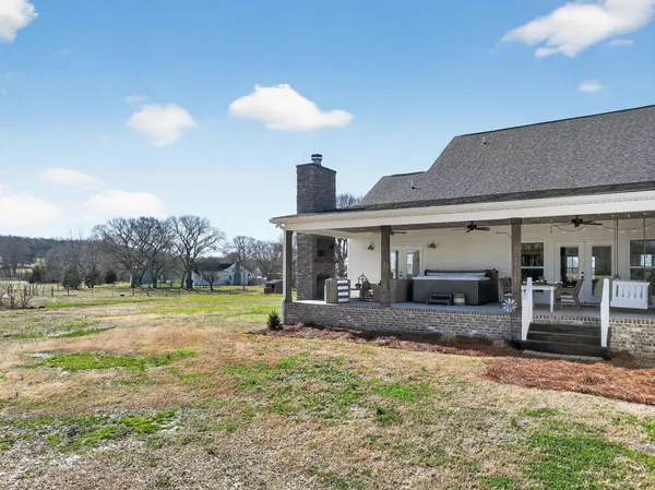 a front view of a house with garden and patio