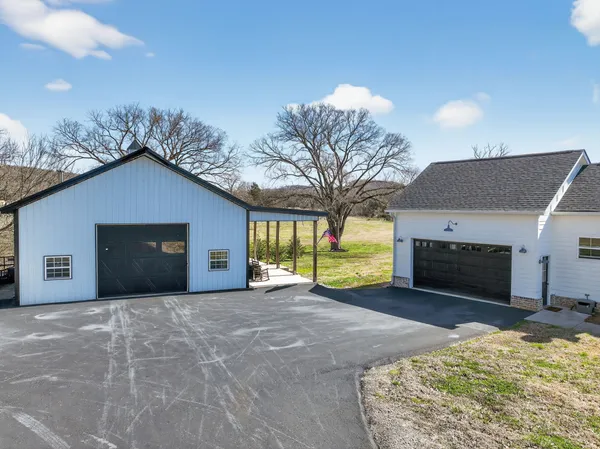 a view of a livingroom with a fireplace and a chandelier