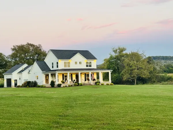 a view of house with garden and deck