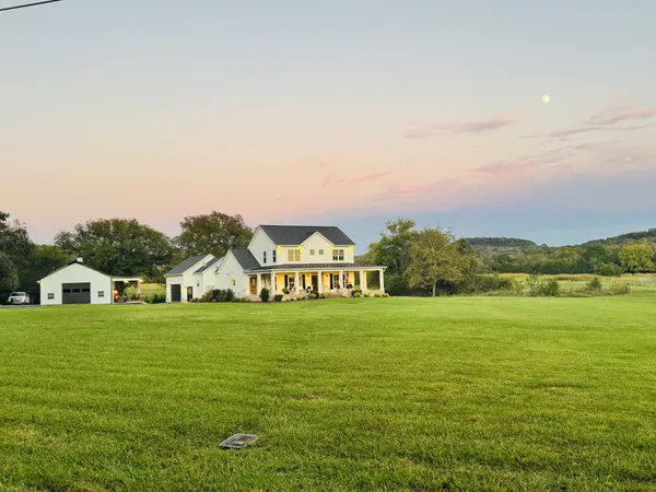 a view of a big yard with an ocean view