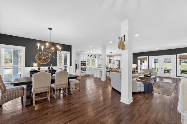 a living room with fireplace furniture and a wooden floor