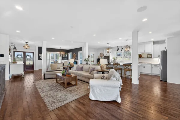 a living room with furniture and wooden floor