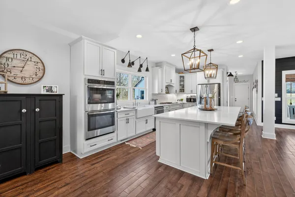 a kitchen with stainless steel appliances a stove top oven a sink and cabinets