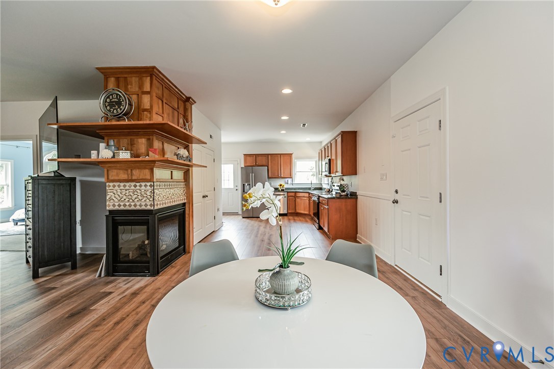 2018 Valentine Road Henrico, VA 23228 - Photo 24 of 65 a view of a dining room with furniture wooden floor fireplace and a chandelier
