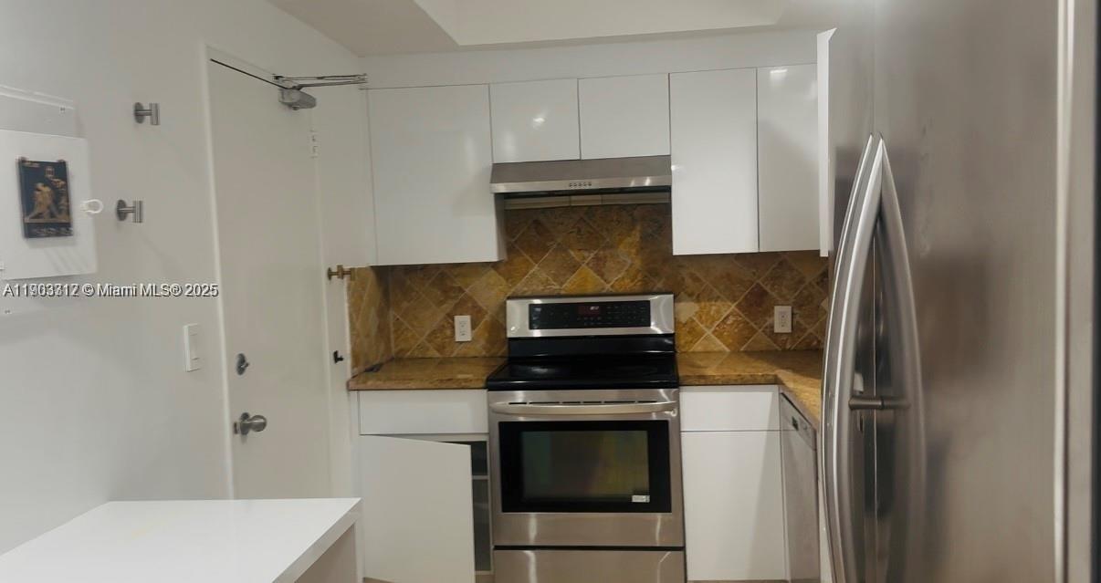 10185 Collins Avenue, Unit 308 Bal Harbour, FL 33154 - Photo 15 of 25 a kitchen with a stove and a refrigerator