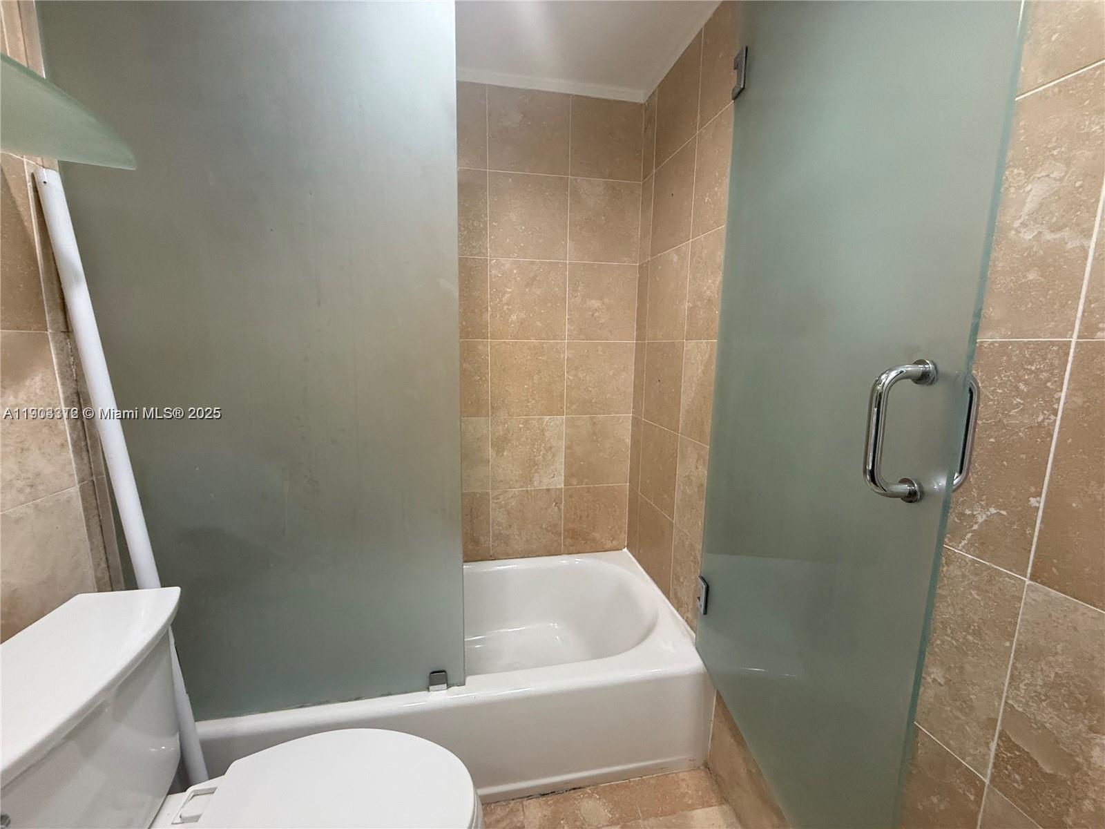 10185 Collins Avenue, Unit 308 Bal Harbour, FL 33154 - Photo 22 of 25 a bathroom with a sink and a tub