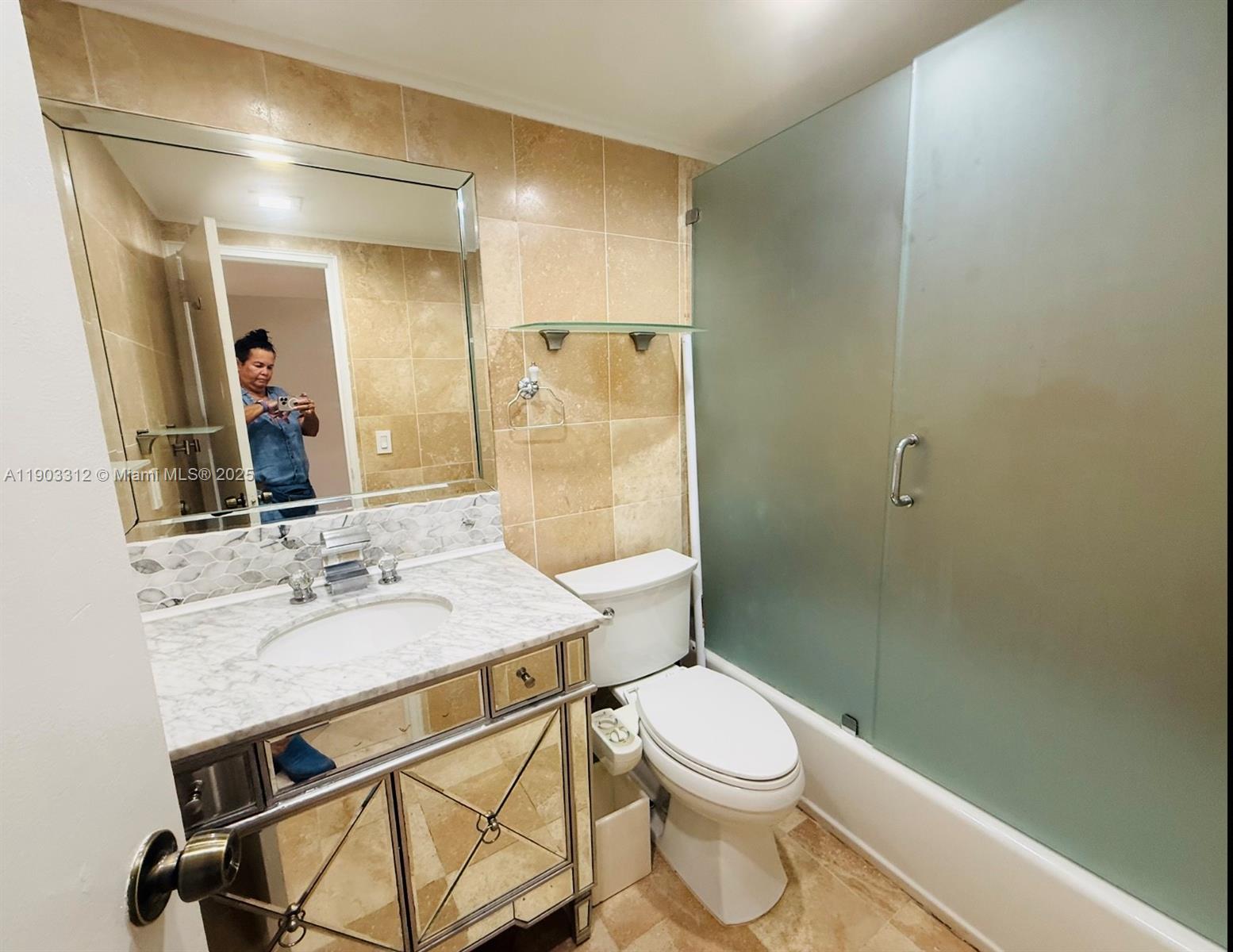 10185 Collins Avenue, Unit 308 Bal Harbour, FL 33154 - Photo 4 of 25 a bathroom with a sink a toilet and shower