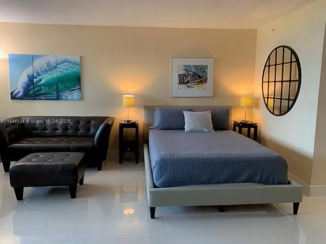 a bedroom with a bed and a wall painting