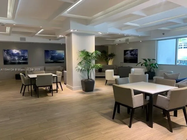a dining room with furniture and wooden floor