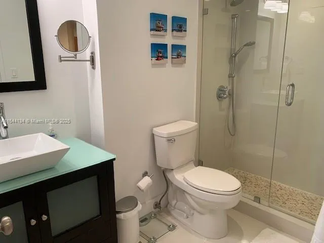 a bathroom with a toilet a sink and shower