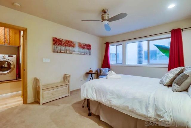 a bedroom with a bed and a large window