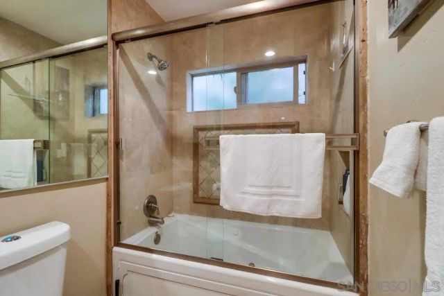 a bathroom with a bathtub and a shower