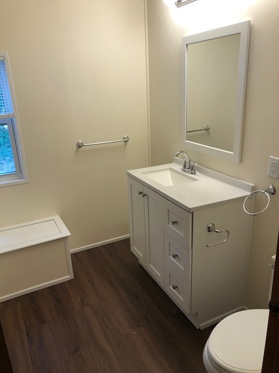 8 Lisa Circle Merrimac, MA 01860 - Photo 14 of 17 a bathroom with a toilet a sink a vanity and mirror