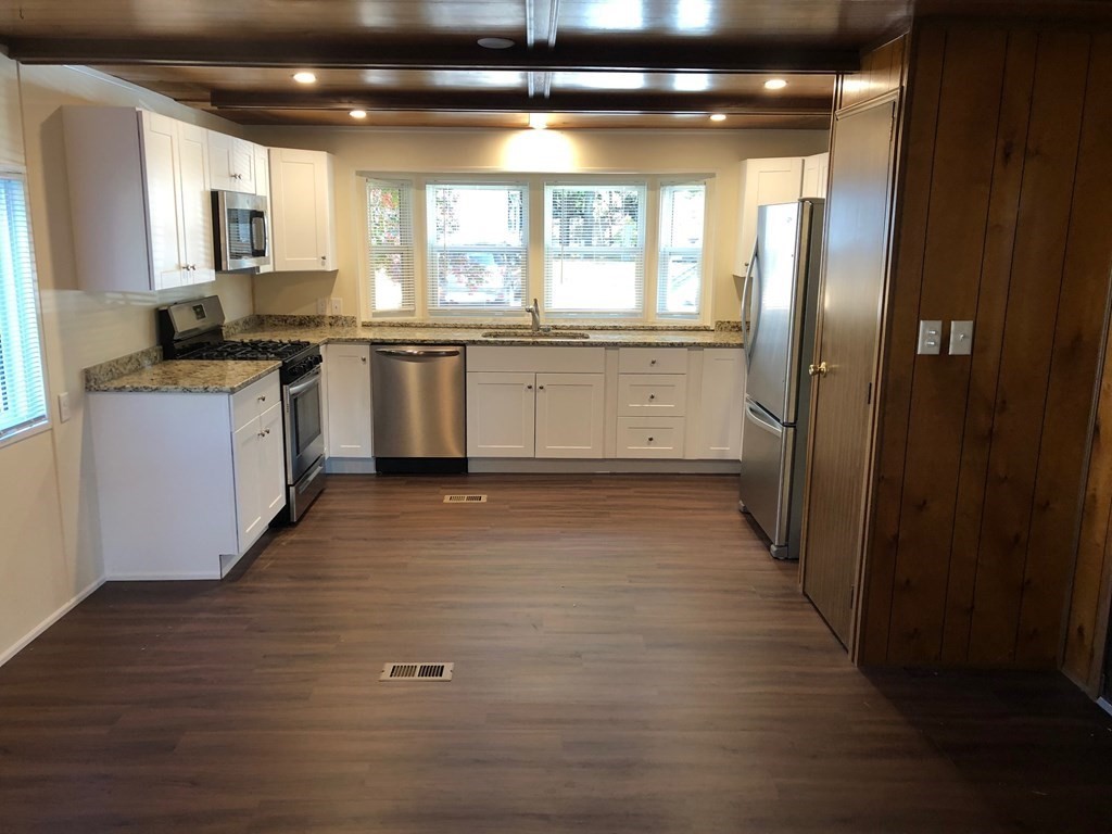 8 Lisa Circle Merrimac, MA 01860 - Photo 6 of 17 a kitchen with granite countertop a stove a sink and a refrigerator