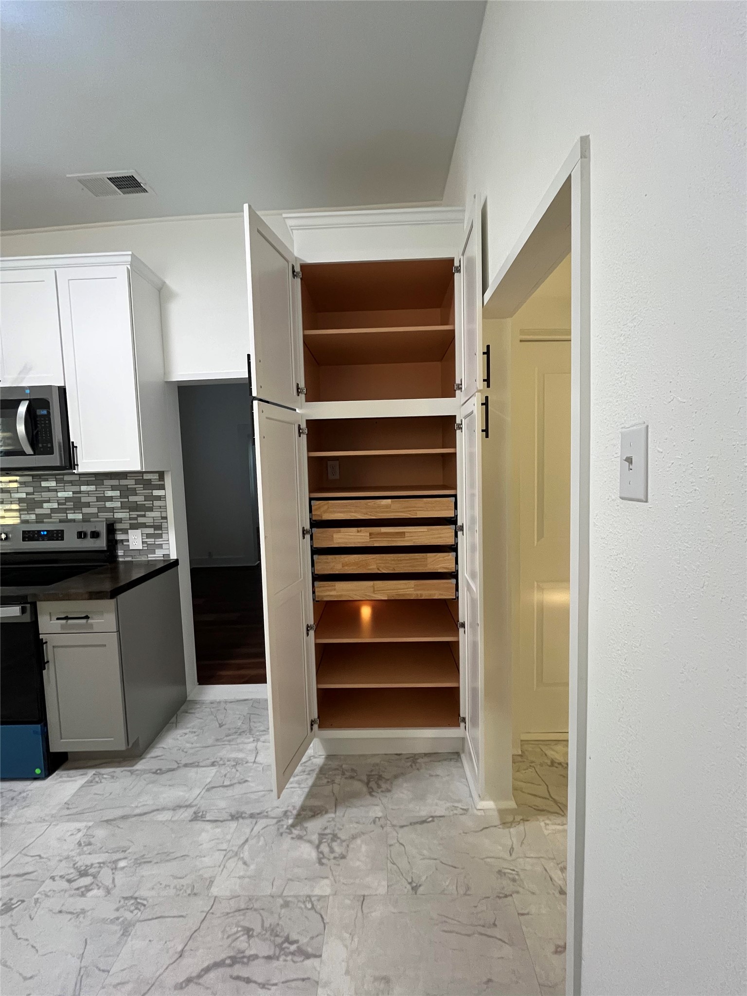 501 North Doak Street Taylor, TX 76574 - Photo 5 of 10 a kitchen with stainless steel appliances a refrigerator and cabinets