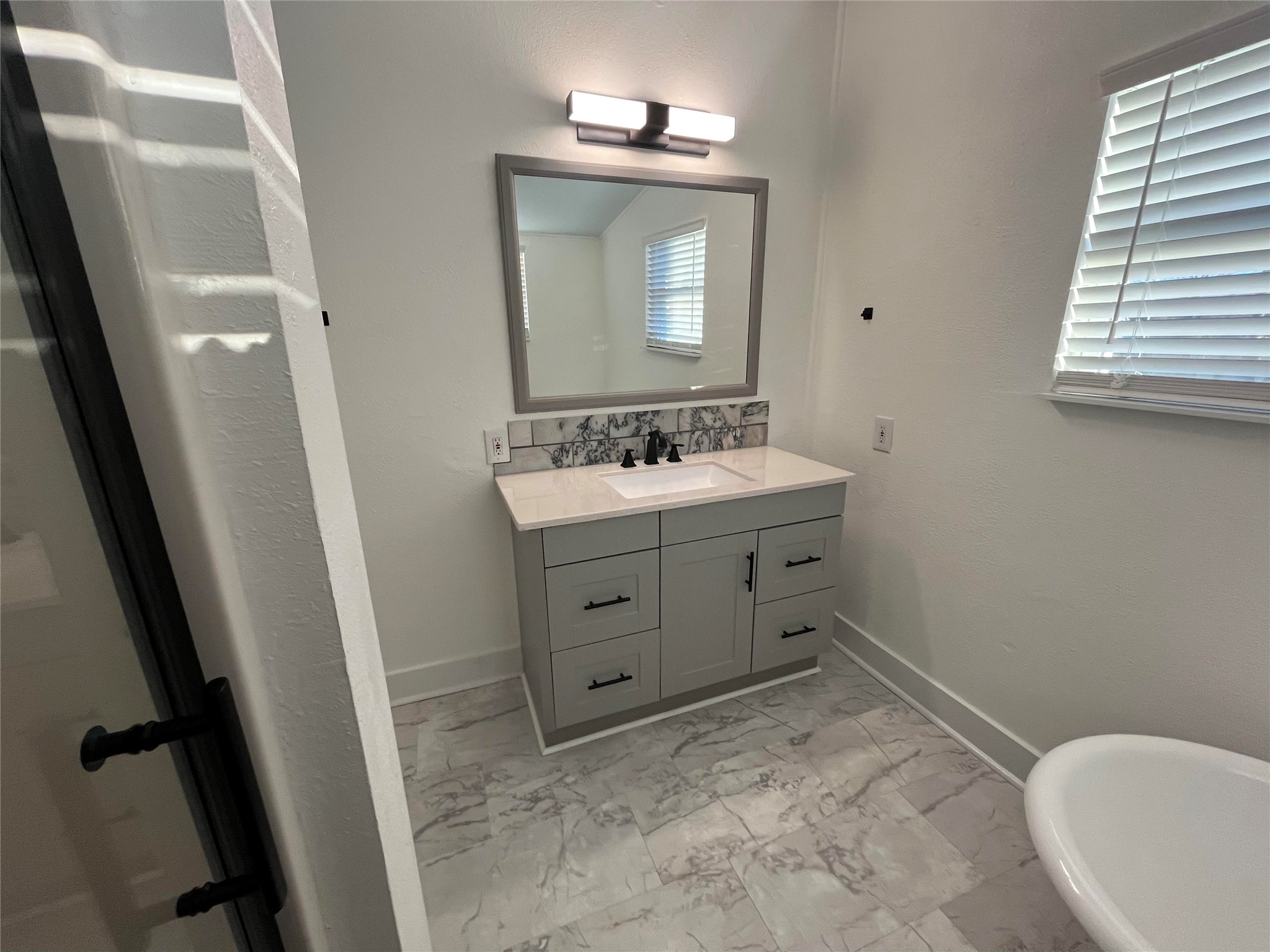 501 North Doak Street Taylor, TX 76574 - Photo 6 of 10 a bathroom with a sink toilet and mirror