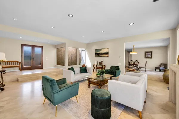 a view of a dining room and a table chairs in a room