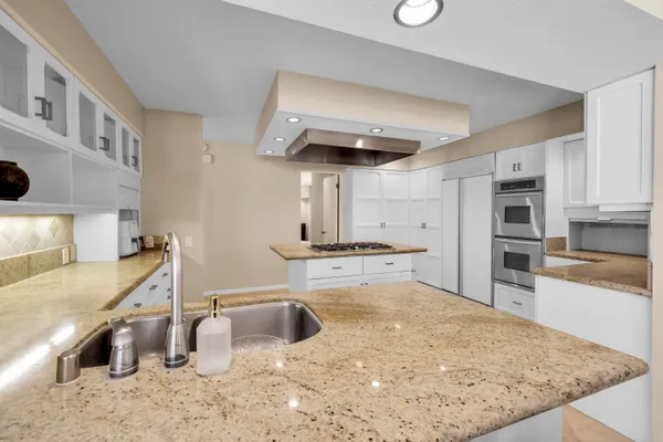 a spacious bedroom with a bed and a large window