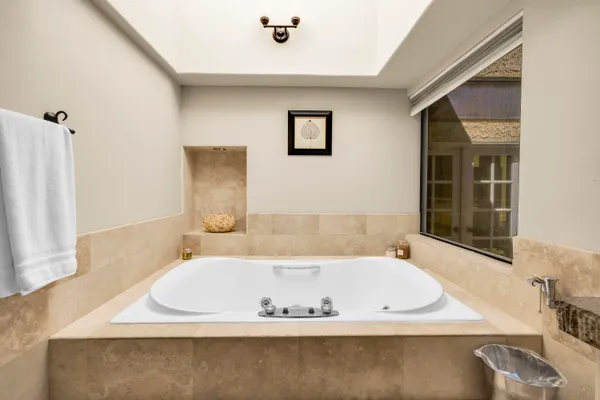 a bathroom with a granite countertop sink a toilet and a mirror