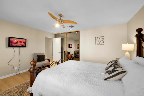 a spacious bedroom with a bed and a dresser