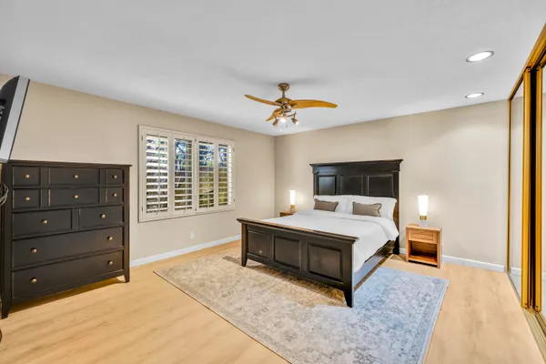 a bedroom with a large bed and a window