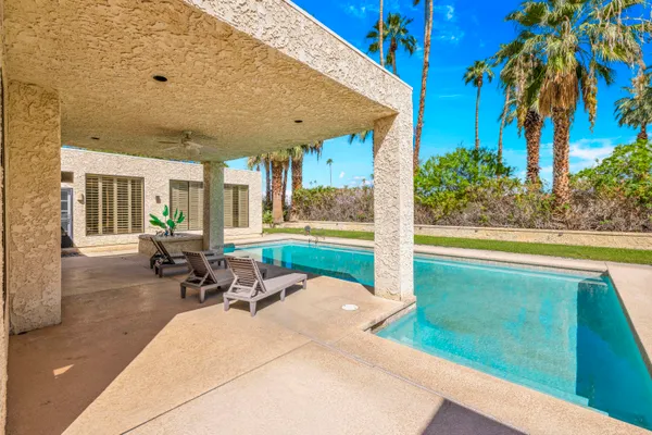 a view of a patio with a table and chairs