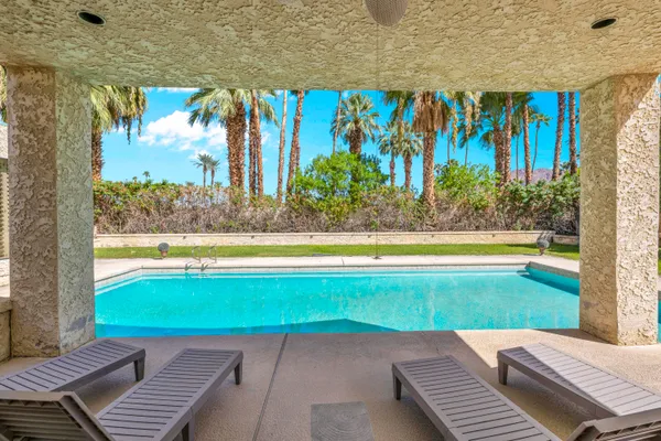 a view of swimming pool with an outdoor space and seating area