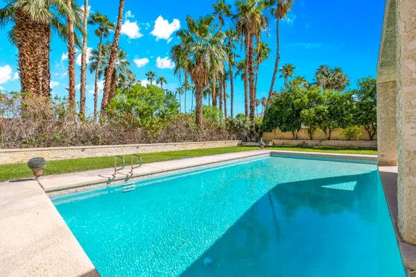 a view of a patio with a table and chairs