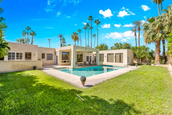 a front view of a house with yard and green space
