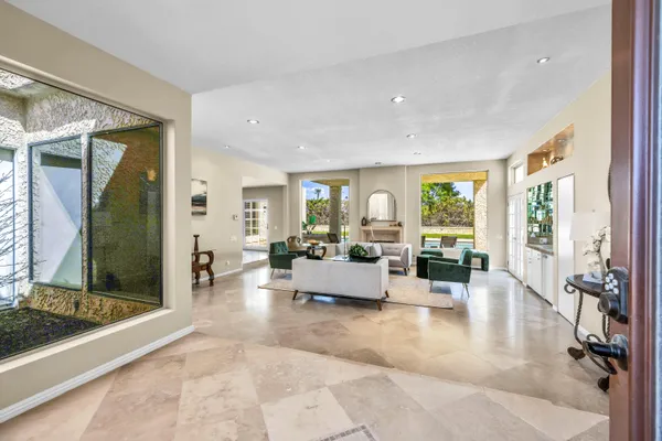 a living room with furniture and large windows